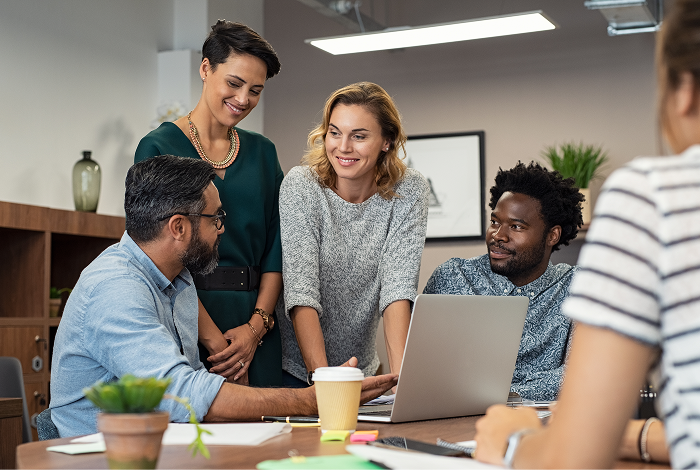 Colleagues collaborating around a table during a workplace meeting