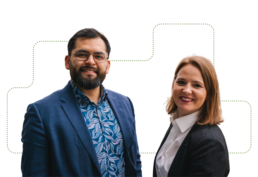 Two employees smiling in a professional portrait for the About Us page