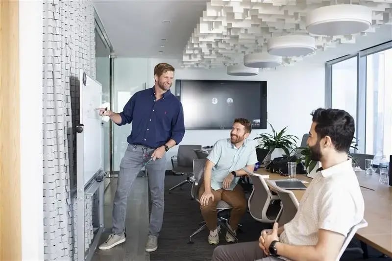 Pricefx team members writing business strategies on a whiteboard in a Chicago meeting room