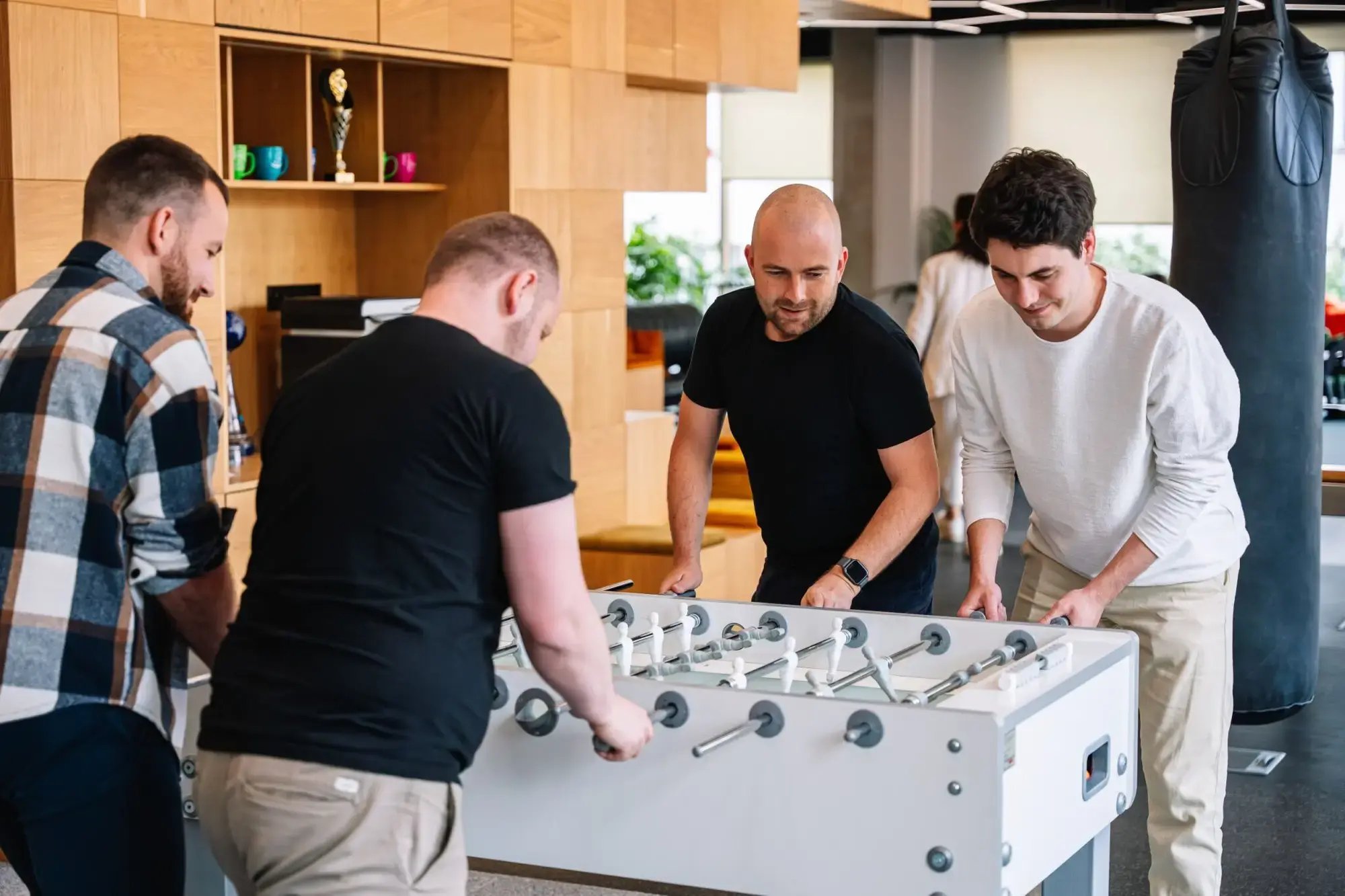 Pricefx team members playing foosball in the Prague office