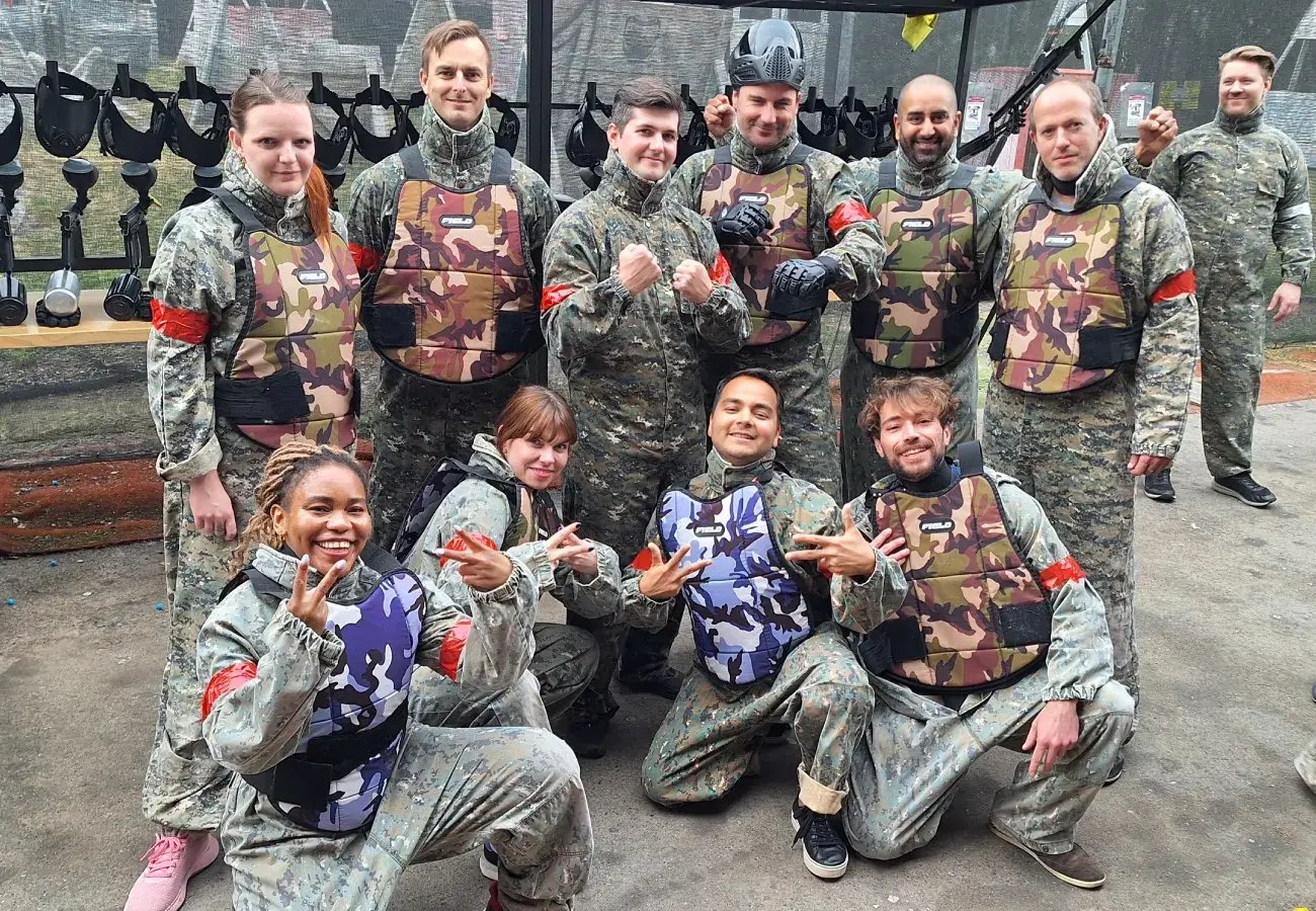  Pricefx employees at an off-site paintball team-building event 