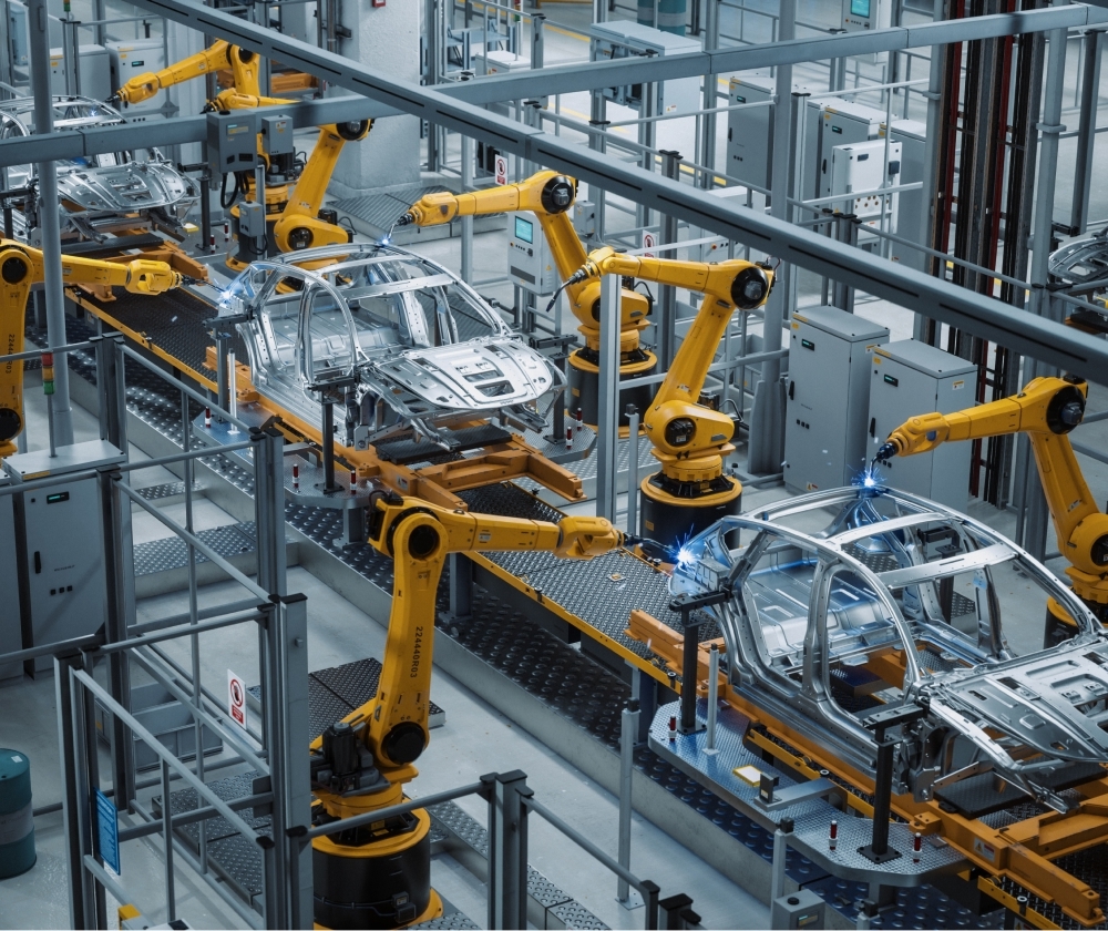 Robotic arms weld car bodies on an automotive assembly line