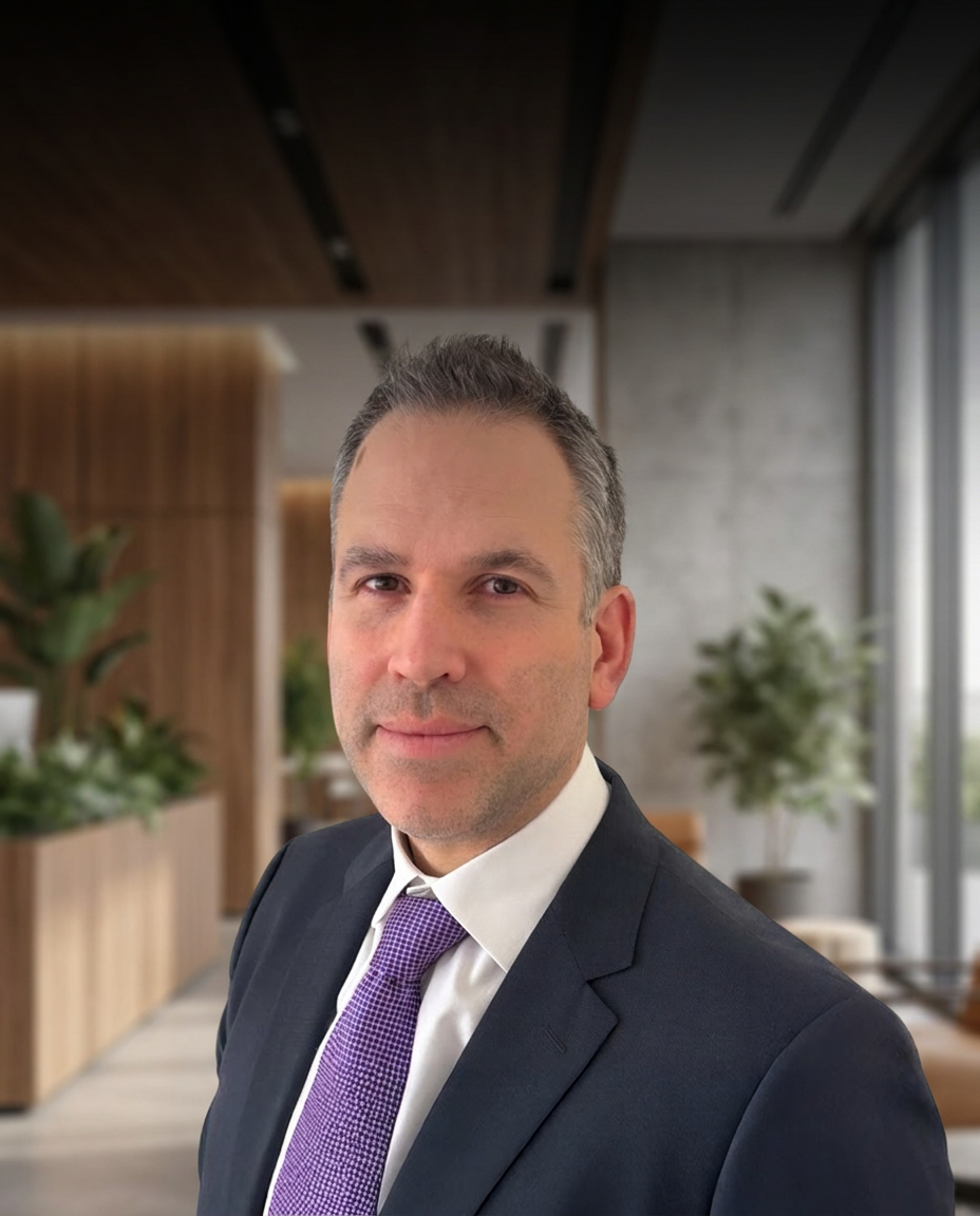 Gary sher in a professional portrait wearing a suit in the office