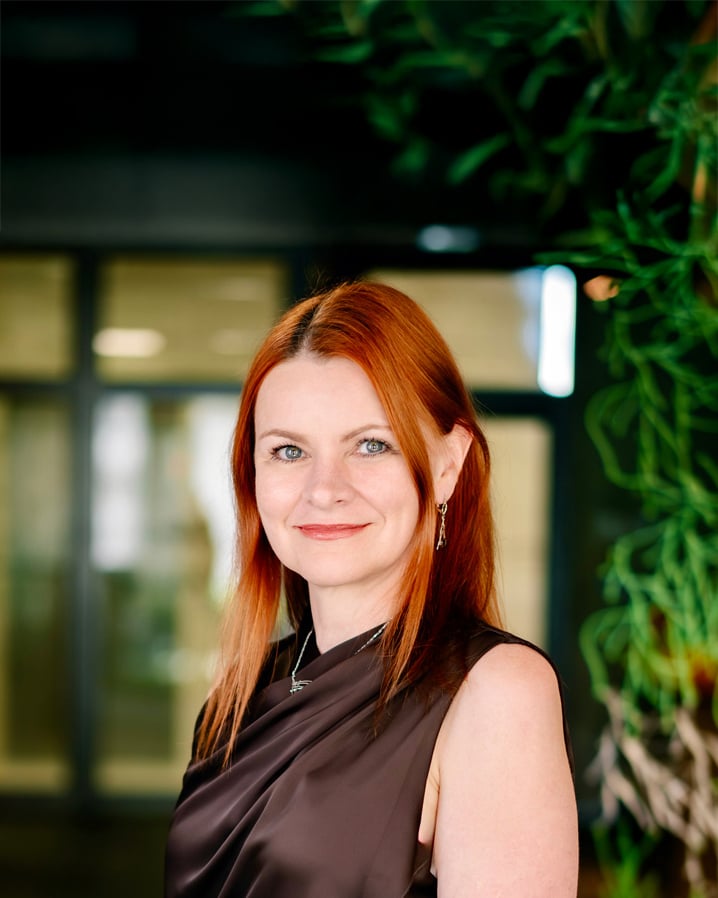 Daniela Hylmarova smiling in a professional portrait in the office
