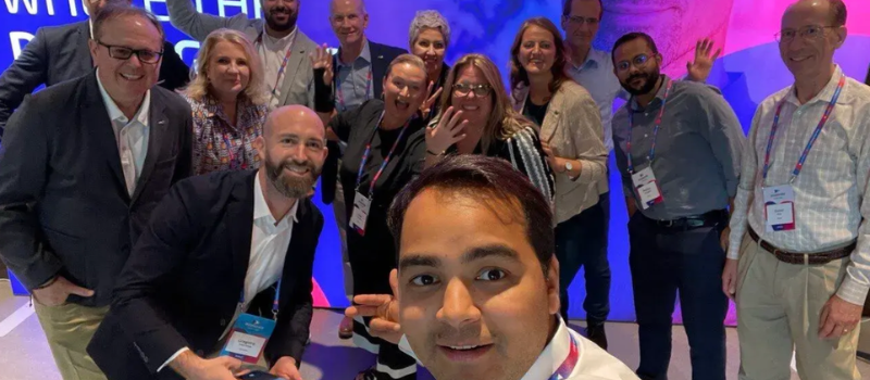 Group selfie at a conference booth in Munich 2023