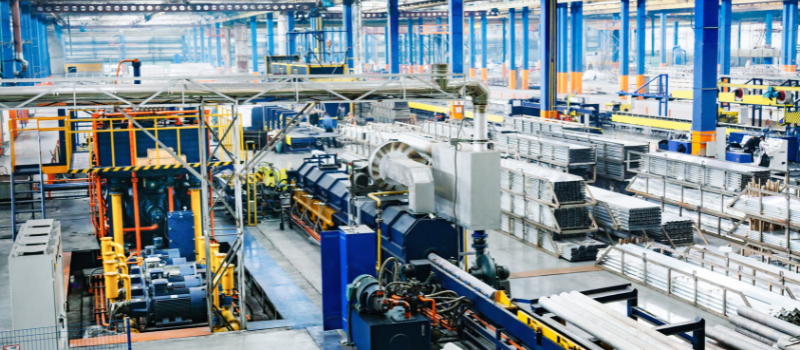 Industrial production line processing metal tubes in a large factory