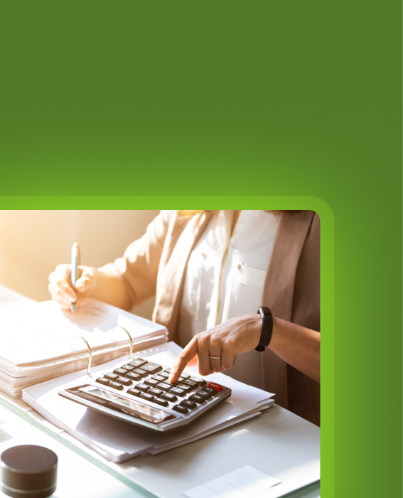 Person using a calculator and notebook to review costs or budget