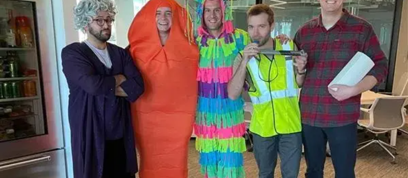 Employees in halloween costumes in office