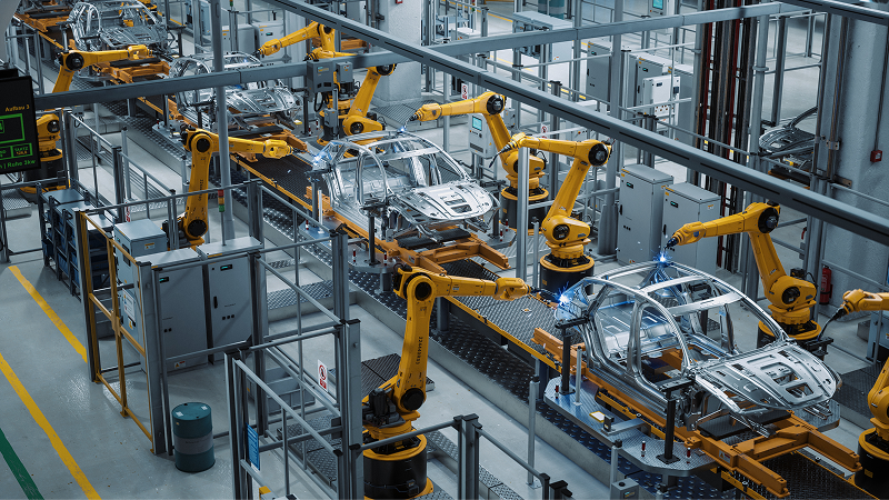 Robotic arms weld car bodies on an automotive assembly line