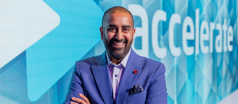 Ronak standing in front of accelerate poster1