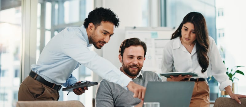 Team reviewing pricing insights together on a laptop
