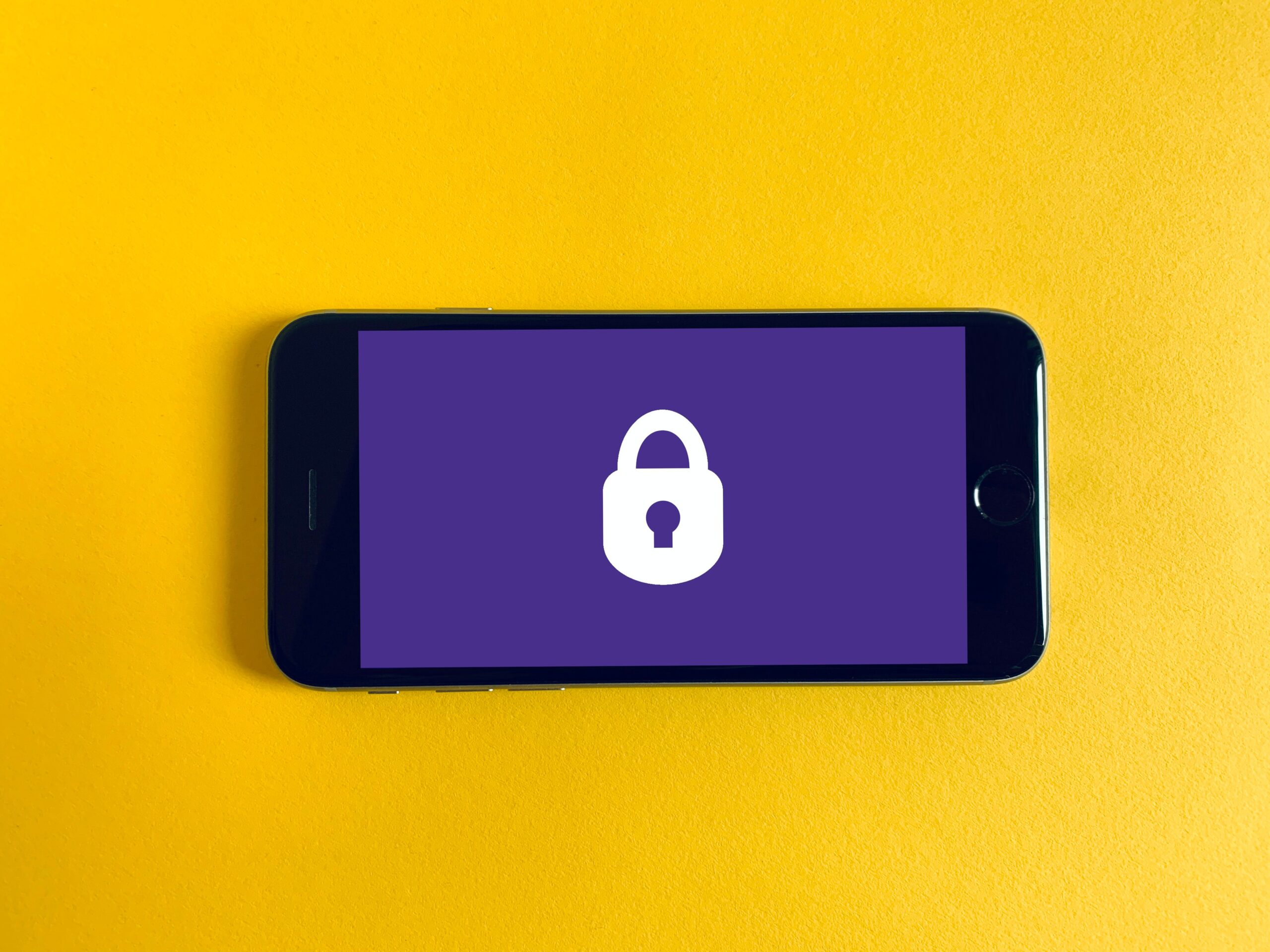 Security-lock-logo-on-smartphone-purple-phone-background-yellow-overall-background