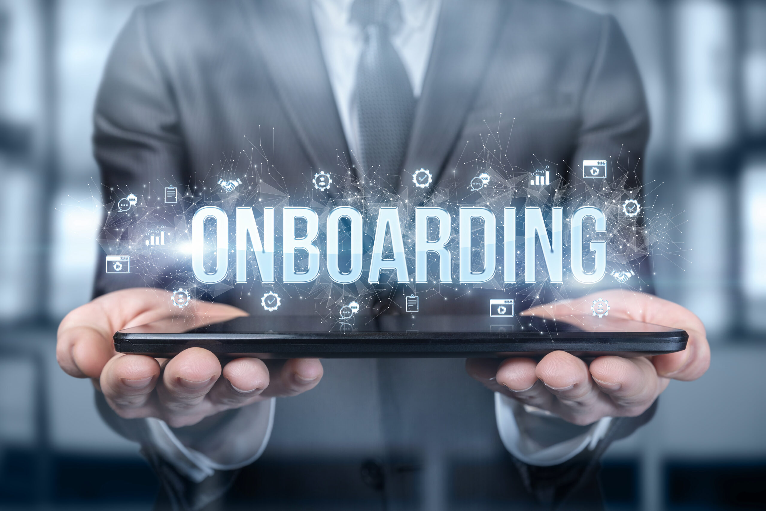 Onboarding-Digital-Image-Floats-Above-Tablet-held-By-Man-In-A-Business-Suit