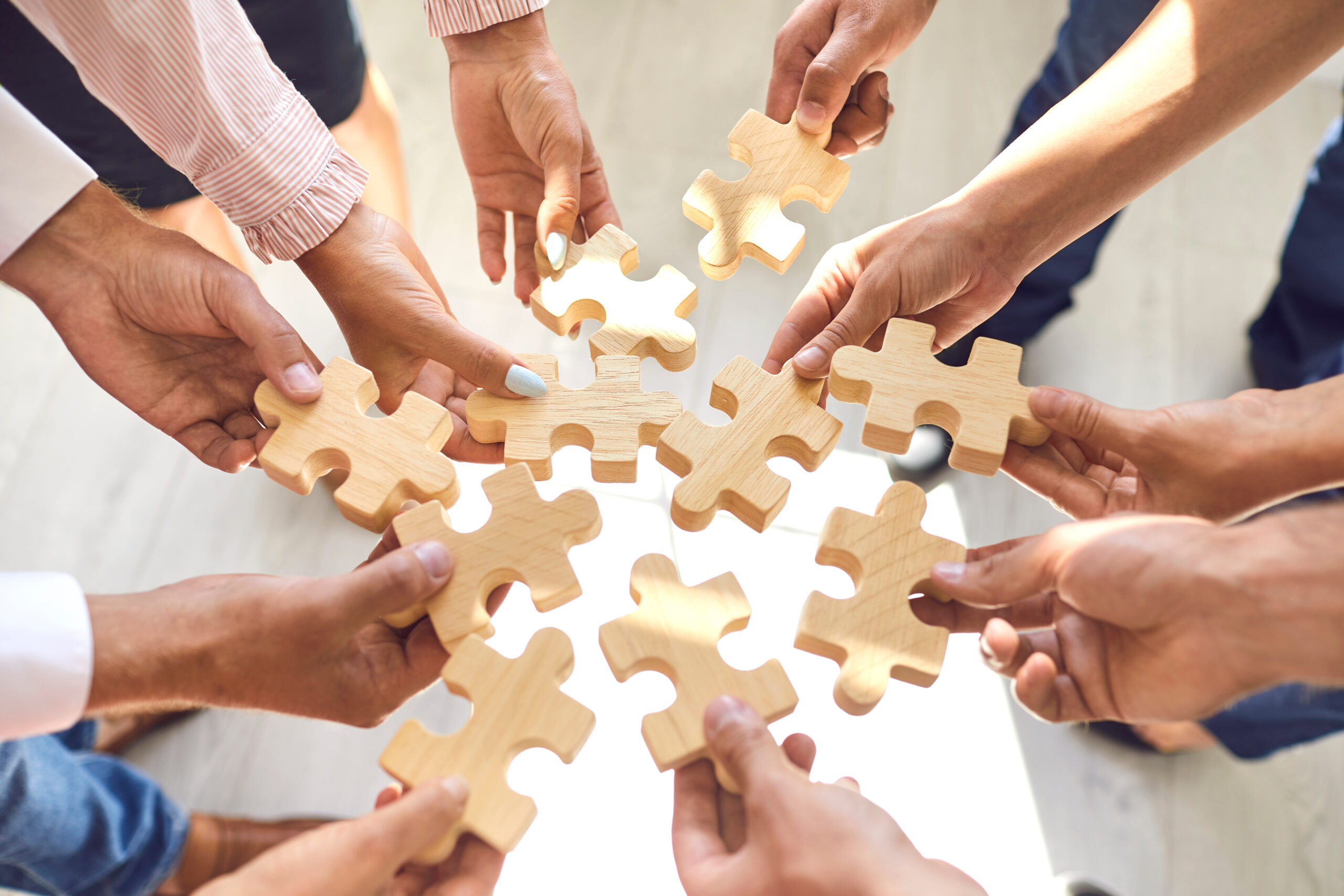 Members-of-the-project-team-all-holding-a-jigsaw-puzzle-piece-of-change-management-process