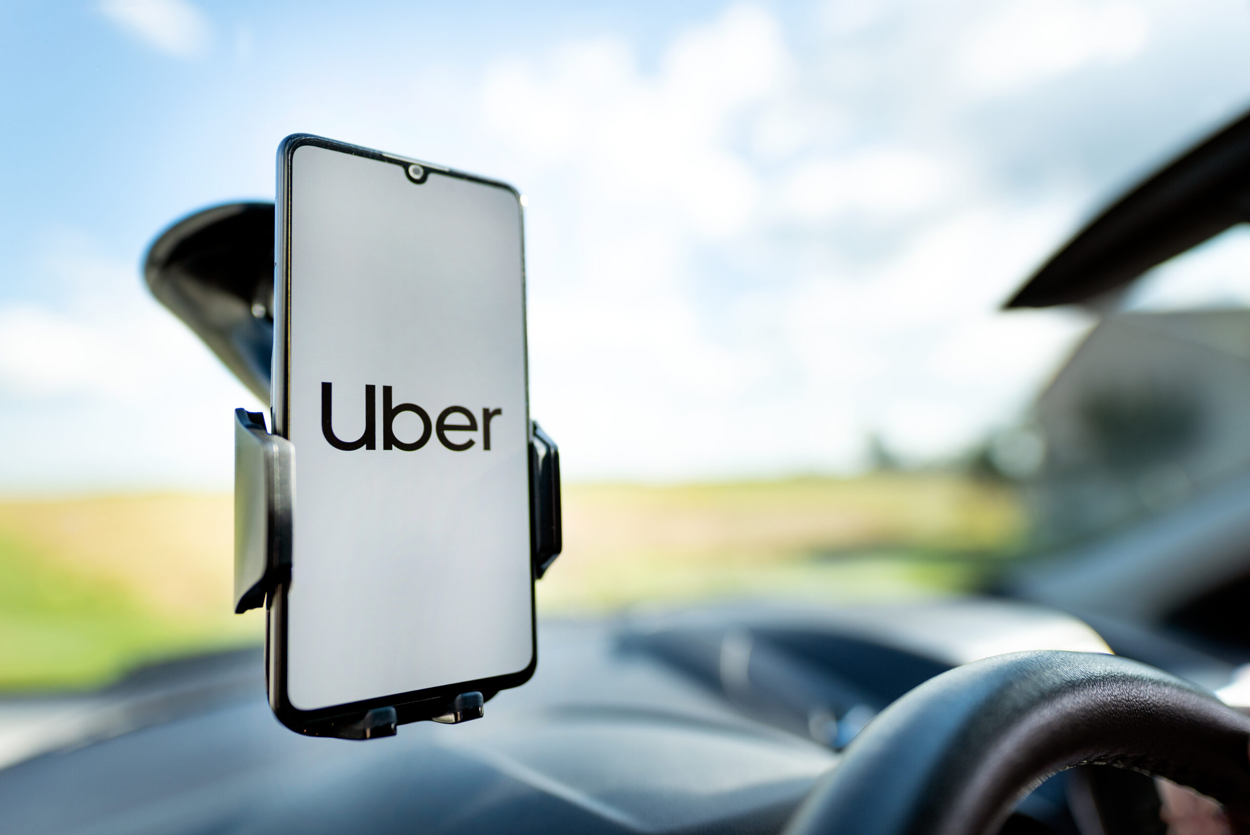Uber-App-Open-on-cell-phone-on-a-car-windscreen-holder
