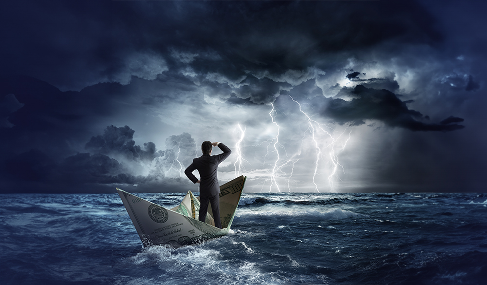 Businessman-in-$100-bill-for-a-boat-looking-ahead-to-confront-economic-downturns-and-storms